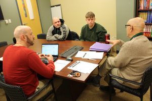 CHS counselor Chris Fournier (left) and Mark Pascale (right) discuss course options with Tim Lajeunesse and his stepson Jordan Prouty.