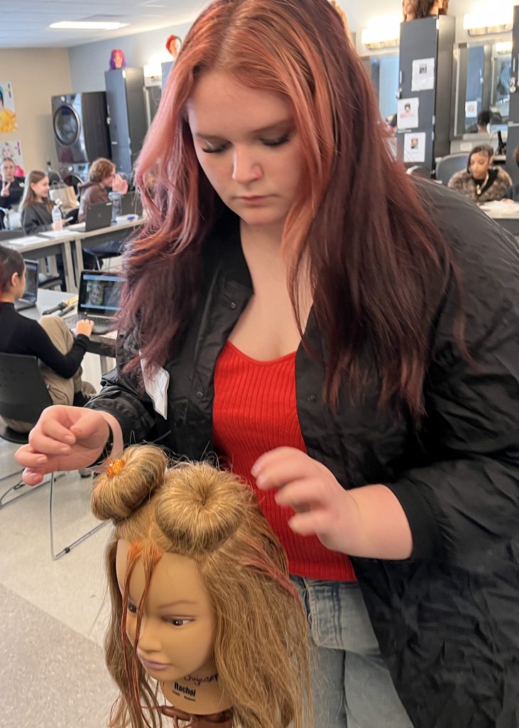 CHS senior doing hair in the cosmetology program at Capital Region Continue Education Center.