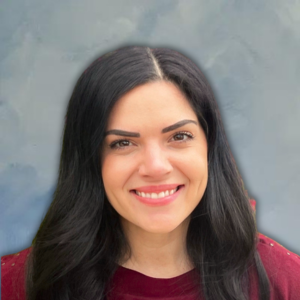 Headshot of Sara in a red sweater