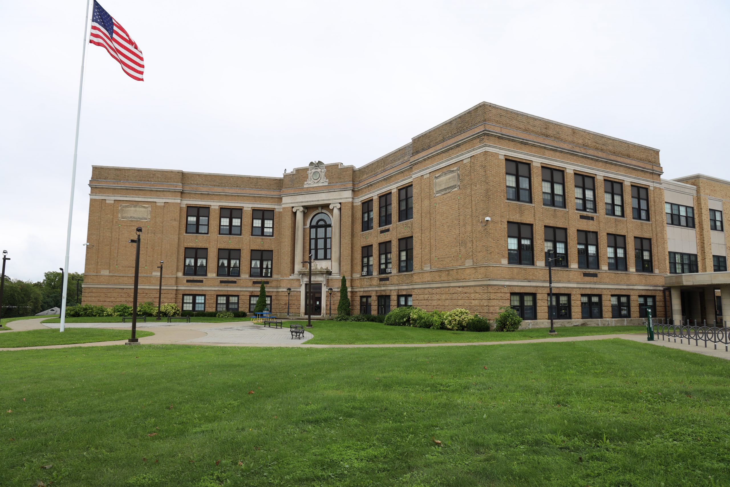 Cohoes Middle School student jumps on chalk path as other students watch