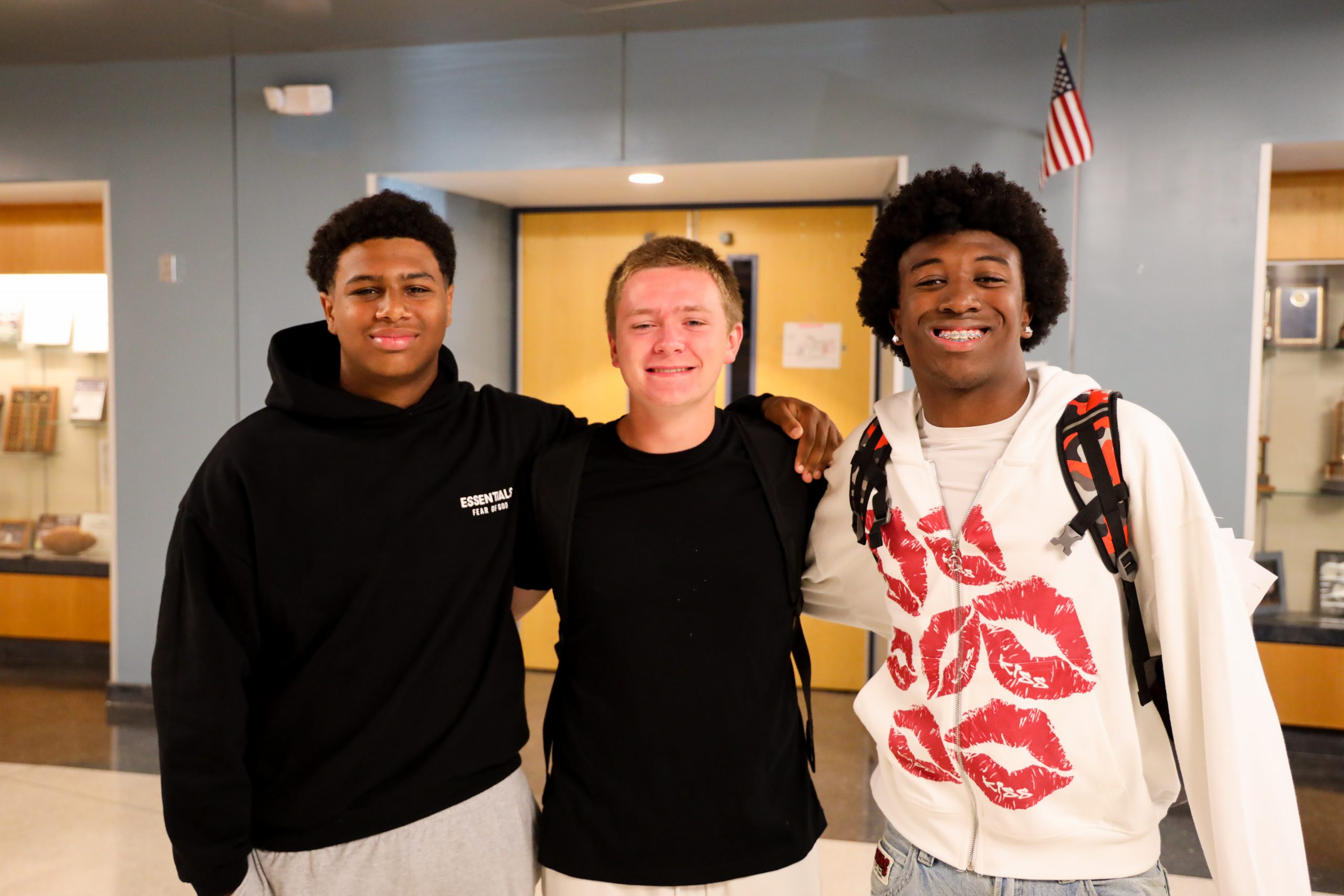 two high school students smile in class